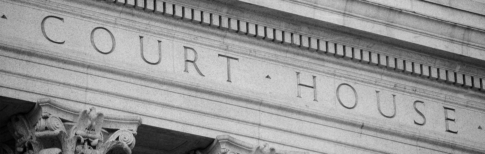 Marble courthouse building facade in black and white.
